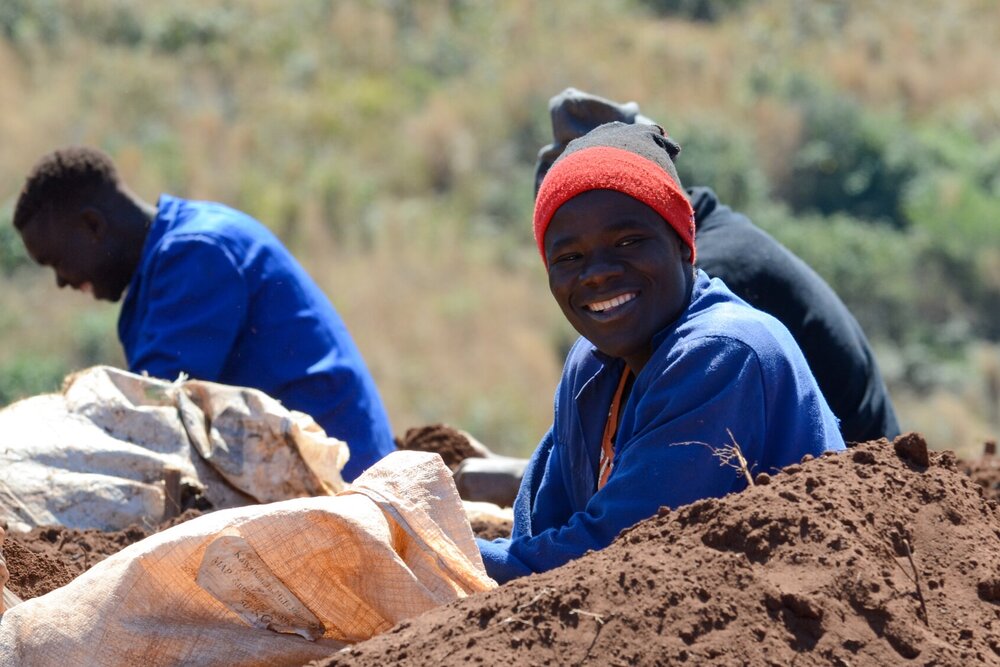 KawandamaHillssmilingstaffpreparingseedpotsinnursery